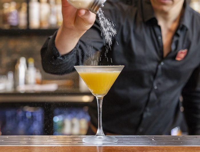 talented bartender making a cocktail at the 1915 cocktail bar