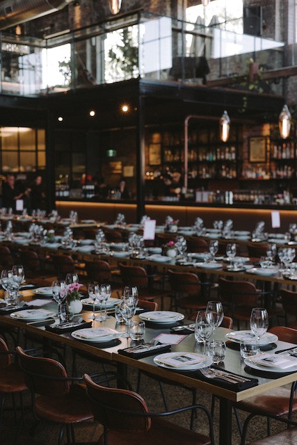 tables set for full venue event & 1915 bar in the background